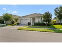 Single-story home with a two-car garage, a well-kept lawn, and landscaping at 2928 Marlberry Ln, Clermont, FL 34714