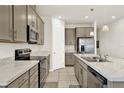 Bright kitchen boasts stainless steel appliances, stone countertops, and ample cabinet storage at 31760 Broadwater Ave, Leesburg, FL 34748