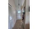 Welcoming entryway with tiled floor, closet and modern light fixture at 3306 Sandy Shore Ln, Kissimmee, FL 34743
