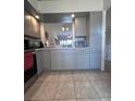 Well-lit kitchen with light grey cabinets and tiled floor at 3306 Sandy Shore Ln, Kissimmee, FL 34743