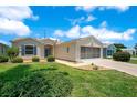 Well-maintained single-Gathering home with a two-car garage, neat landscaping and excellent curb appeal at 33417 Pennbrooke Pkwy, Leesburg, FL 34748