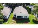 An aerial view of the backyard shows the home's location in the neighborhood with a patio at 3718 Westerham Dr, Clermont, FL 34711