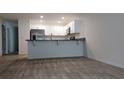 Bright kitchen featuring white cabinets and modern wood flooring at 435 Woodview Dr, Tavares, FL 32778