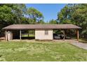 Covered outbuilding with parking and storage on a verdant lawn, offering ample space for vehicles and equipment at 5581 Sw 197Th Ter, Dunnellon, FL 34431