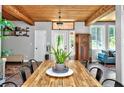 Elegant dining room featuring a wood ceiling, decorative lighting, and views of the outside at 640 Sailfish Rd, Winter Springs, FL 32708