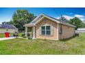 Inviting single-story home with a cozy front porch and neat lawn, perfect for comfortable living at 6710 Winkles St, Coleman, FL 33521
