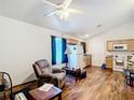 Cozy living room featuring hardwood floors, a comfy recliner, and ample natural light at 6710 Winkles St, Coleman, FL 33521