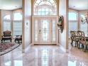 Bright foyer with elegant marble flooring and a decorative front door at 812 Eagle Claw Ct, Lake Mary, FL 32746