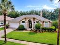 Well-manicured lawn and landscaping, and a classic exterior paint scheme at 812 Eagle Claw Ct, Lake Mary, FL 32746