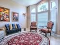 Cozy sitting room with a large arched window, elegant furnishings and a decorative rug at 812 Eagle Claw Ct, Lake Mary, FL 32746