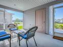 Enclosed patio features cozy wicker furniture, offering a comfortable space for outdoor relaxation and enjoyment at 865 Conroe St, The Villages, FL 34762
