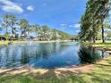 Scenic view of a serene pond with a fountain at 105 Temple W Cv, Leesburg, FL 34748