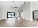 Bright and airy living room featuring a high ceiling, ceiling fan, and access to the outdoor pool area at 12838 Owasso Ln, Clermont, FL 34711