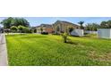 Charming one-story home with well-manicured lawn and beautiful landscaping, creating curb appeal at 13100 Lakewind Dr, Clermont, FL 34711