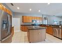 Well-equipped kitchen with stainless steel appliances, granite countertops, and ample cabinet space at 13100 Lakewind Dr, Clermont, FL 34711