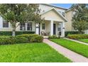 Charming townhome with a well-maintained lawn, brick walkway, and inviting front porch at 14421 Vashons Way, Winter Garden, FL 34787