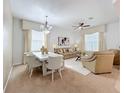 Open-concept living space with dining area, plush seating, elegant décor, and plenty of natural light at 1454 Westbury Dr, Clermont, FL 34711