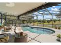 Relaxing screened-in pool area offering a serene view of the lush golf course at 15837 Hidden Lake Cir, Clermont, FL 34711