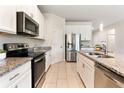 Spacious kitchen with granite countertops, stainless steel appliances, and ample cabinet space at 17112 Goldcrest Loop, Clermont, FL 34714
