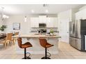 Well-equipped kitchen featuring stainless steel appliances, granite counters, and seating at the island at 17112 Goldcrest Loop, Clermont, FL 34714