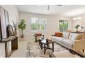 Bright living room with neutral tones, tile flooring, and large windows for natural light at 17112 Goldcrest Loop, Clermont, FL 34714