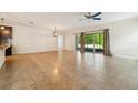 Spacious living room featuring tile flooring, ceiling fan, and sliding glass doors at 185 Hamlet Loop, Davenport, FL 33837