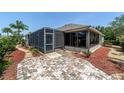 Relaxing outdoor space with screened enclosure and brick paver patio, perfect for enjoying the outdoors at 1910 Quiet Oak Ct, The Villages, FL 32162