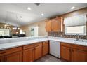 Bright, modern kitchen with white countertops, wood cabinets, mosaic tile backsplash, and stainless steel appliances at 2050 Duval Ct, The Villages, FL 32162