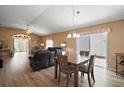 Open-concept living and dining area with wood floors, sliding glass doors, and comfortable seating at 2050 Duval Ct, The Villages, FL 32162