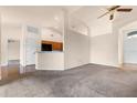 Open-concept living room showcasing neutral walls, plush carpeting, and easy access to the kitchen area at 211 Highland Meadows Ct, Davenport, FL 33837