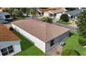 Aerial view of the home's roof, siding and backyard with well-maintained lawn at 2111 Thornton Ter, The Villages, FL 32162