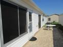 Back patio with ample space for entertaining, showcasing the outdoor living area and backyard at 2388 Branchville Ter, The Villages, FL 32162