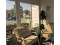 Cozy sunroom featuring comfortable seating and scenic views of the surrounding neighborhood at 2388 Branchville Ter, The Villages, FL 32162