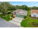 Beautiful single-Gathering home with a two-car garage, lush landscaping, and a well manicured lawn in a desirable area at 25236 Waterbridge Ct, Leesburg, FL 34748