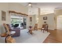 Bright living room featuring vaulted ceilings, neutral walls, and sliding doors to the outdoor patio at 25236 Waterbridge Ct, Leesburg, FL 34748