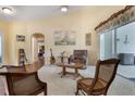 Bright living room featuring vaulted ceilings, neutral walls, and sliding doors to the outdoor patio at 25236 Waterbridge Ct, Leesburg, FL 34748