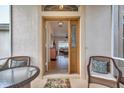 Inviting entryway featuring a beveled-glass door, seating, and views into the living area at 27146 Greenfly Orchid Ln, Leesburg, FL 34748
