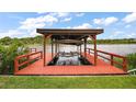 Covered boat lift on the water's edge, providing easy access for boating at 31941 Tropical Shores Dr, Tavares, FL 32778
