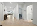 Bright hallway featuring tile flooring that flows into an open living space with furniture at 33960 Sky Blossom Cir, Leesburg, FL 34788