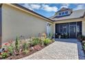 Beautiful garden landscaping with paved walkway and cozy seating area with a screened-in porch at 3519 Arlington Ridge Blvd, Leesburg, FL 34748