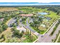 Stunning aerial view of community amenities, including pool, tennis courts, and lake at 3550 Fairwaters Ct # D, Clermont, FL 34711