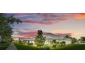 Picturesque street view of single-story homes with colorful sunset backdrop at 3550 Fairwaters Ct # D, Clermont, FL 34711
