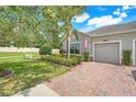Charming home with brick driveway, well-kept lawn, and an American flag at 3550 Fairwaters Ct # D, Clermont, FL 34711