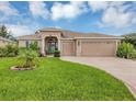Spacious single-story home featuring a manicured lawn, three-car garage, and neutral stucco exterior at 3809 Arlington Ridge Blvd, Leesburg, FL 34748