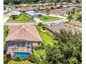 Aerial view of a backyard pool with a screened lanai in a residential neighborhood at 3809 Arlington Ridge Blvd, Leesburg, FL 34748