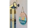 Charming 'Beach Bums Welcome' sign by a bright yellow door adds a whimsical touch at 40140 Palm St, Lady Lake, FL 32159