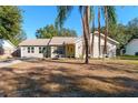Well-maintained single-story home with a welcoming facade and yellow door at 40140 Palm St, Lady Lake, FL 32159