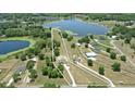 Aerial view of large property with lake, treeline, and perimeter outlined in white at 40143 Babb Rd, Umatilla, FL 32784