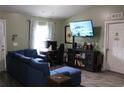 Comfortable living room with ample seating, large screen TV, and natural light at 41 Dogwood Loop, Ocala, FL 34472
