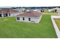 Spacious backyard with lush green grass, offering plenty of room for outdoor activities and relaxation at 5547 Se 91St Pl, Ocala, FL 34480